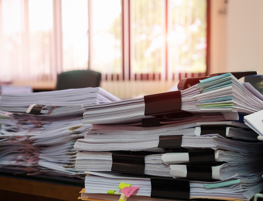 Close Up of Bundled and Stacked Documents on Table @kanchanachitkhamma via Canva